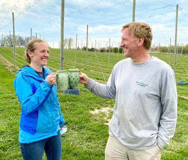 hop growers of michigan members cheers with michigan beer in chinook prize cups