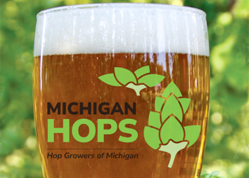 hop growers of michigan brewer members with beer glass showing hgm logo